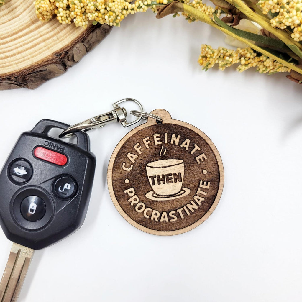 Caffeinate then procrastinate engraved circle keychain on a car key