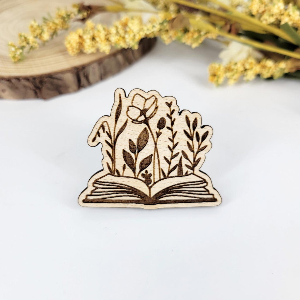 Flowers emerging from an open book engraved wooden pin