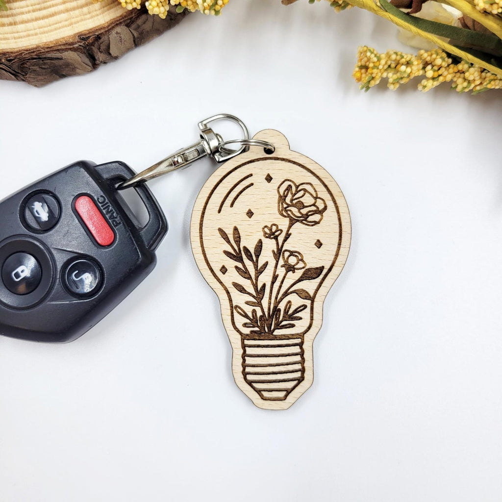 Flowers in a lightbulb- engraved wooden keychain