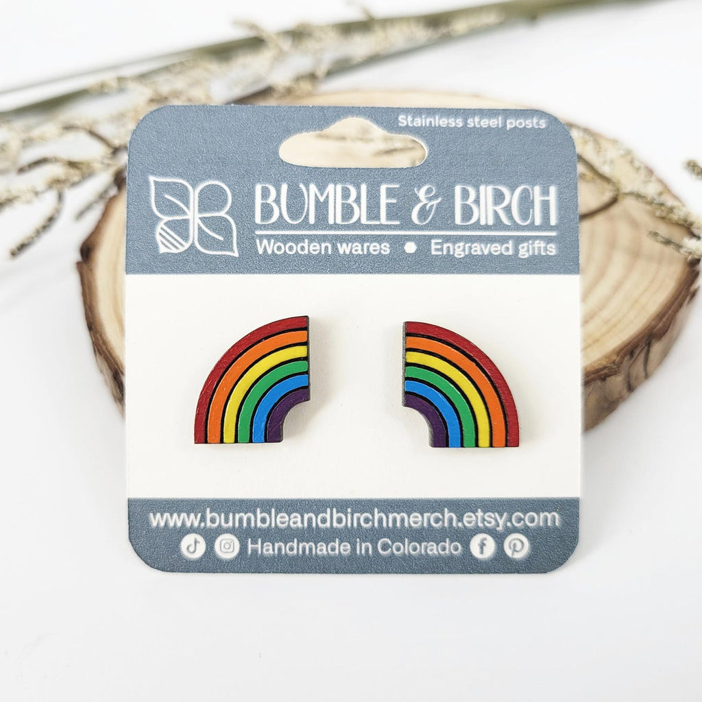 Half rainbow colored stud earrings with packaging