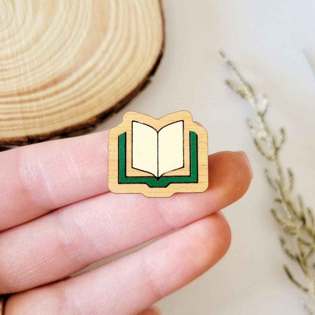 Green book shaped, engraved wooden pin