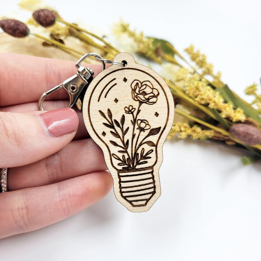 Flowers in a lightbulb- engraved wooden keychain