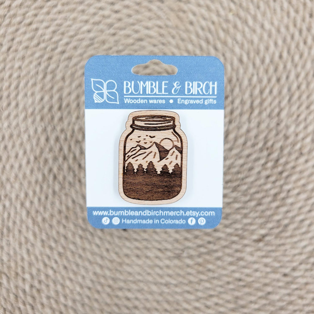 Mountains in a mason jar wood pin with packaging
