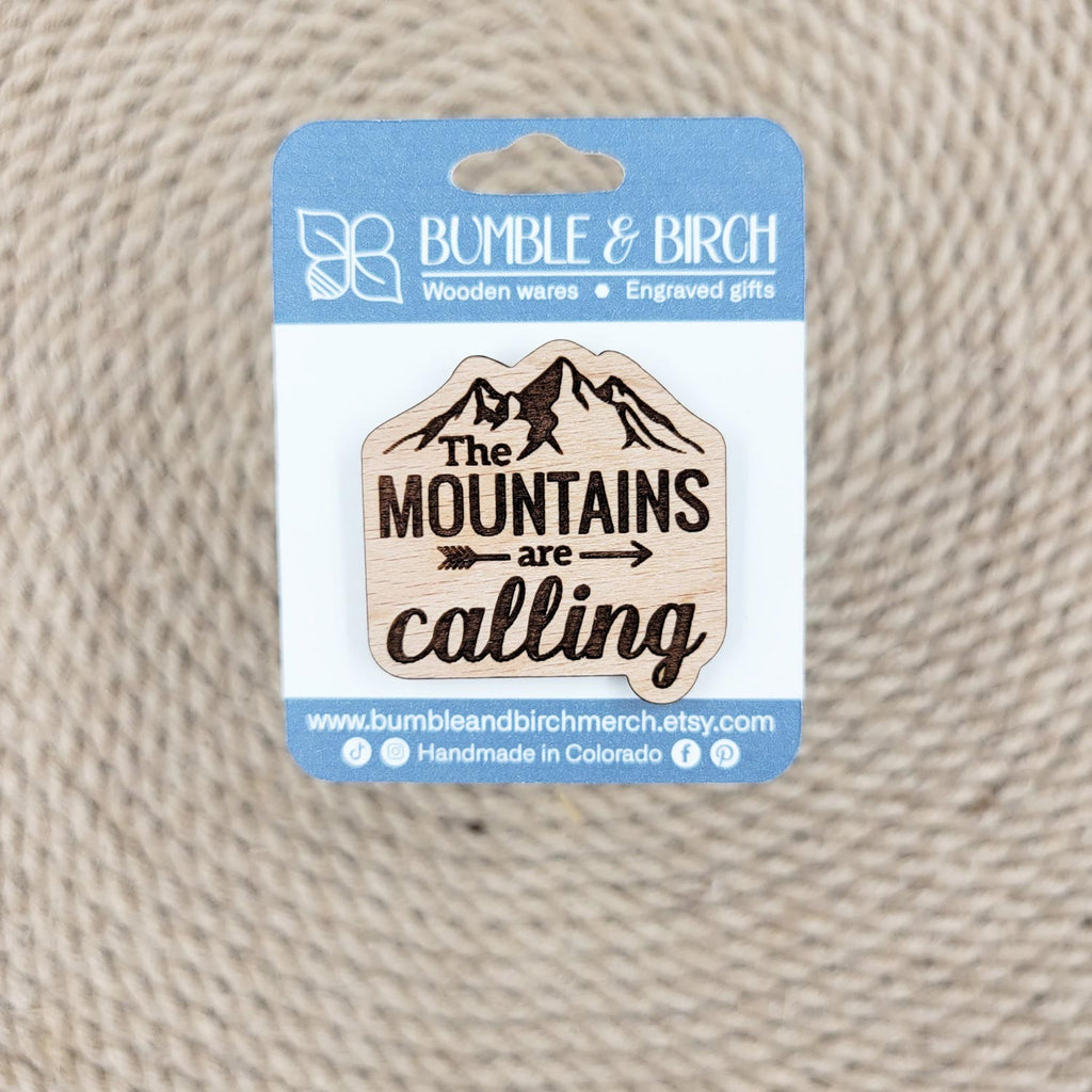The mountains are calling engraved wood pin with packaging