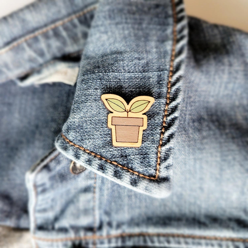 Potted plant seedling shaped wooden pin on a collar