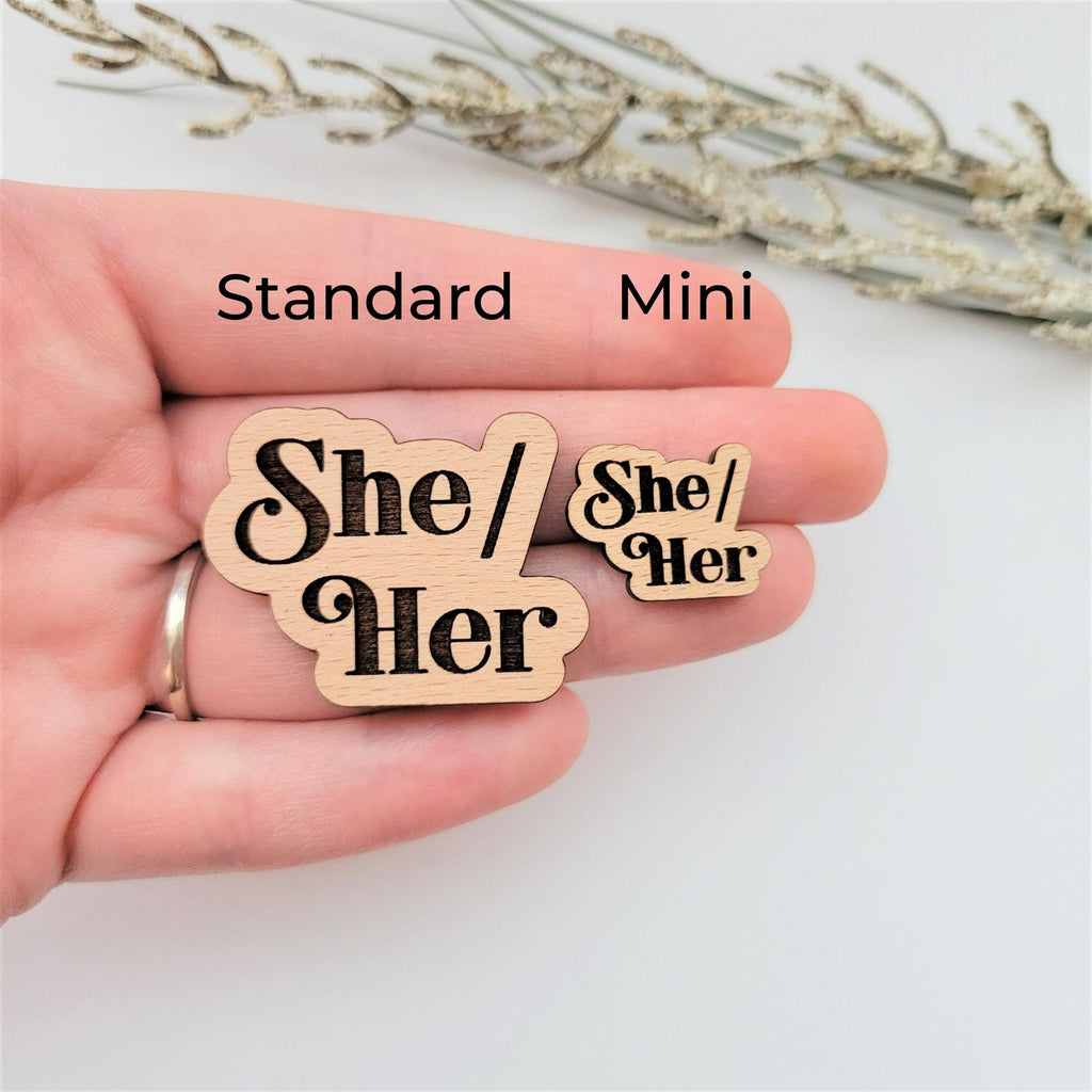 She/her wood pin, standard and mini size